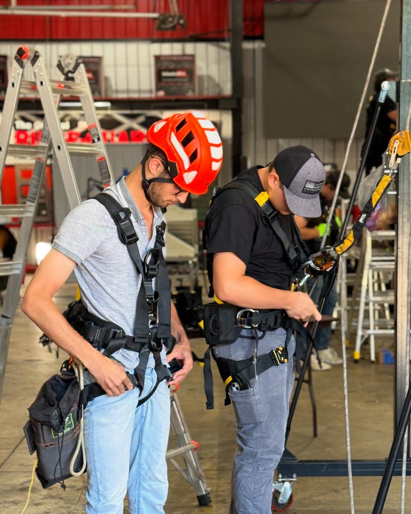 OSHA compliant students adjusting PFA harnesses and lifelines before roof access